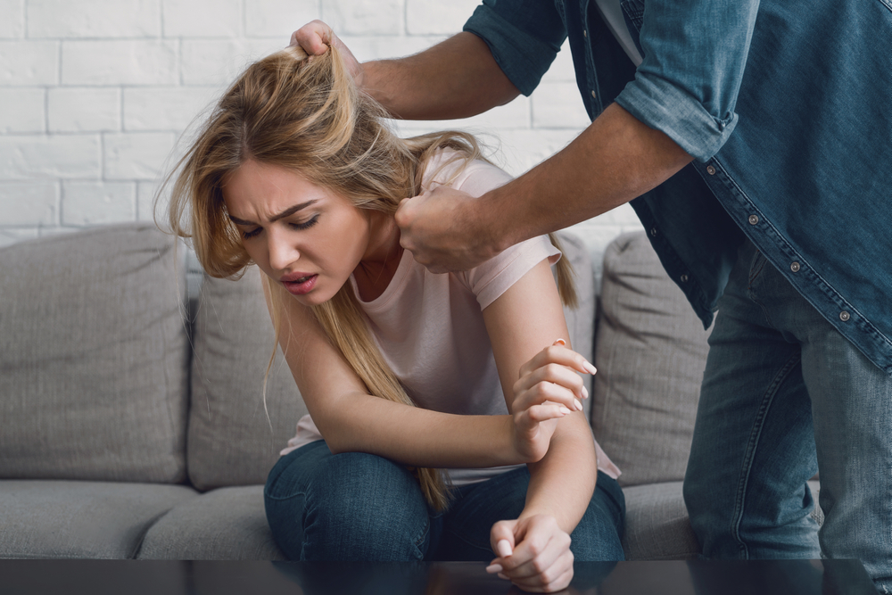 Domestic violence. Man threatens woman by grabbing her hair, girl face expresses pain
