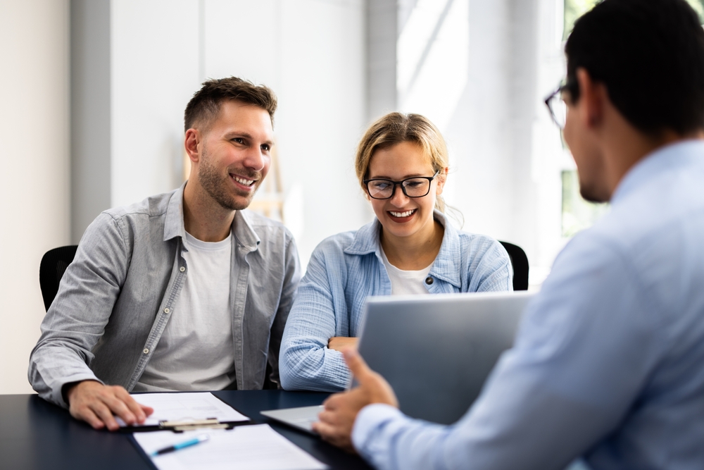 Young Couple Is Meeting With A Financial Planner To Discuss Their Future Investments And Family Finances In An Office.